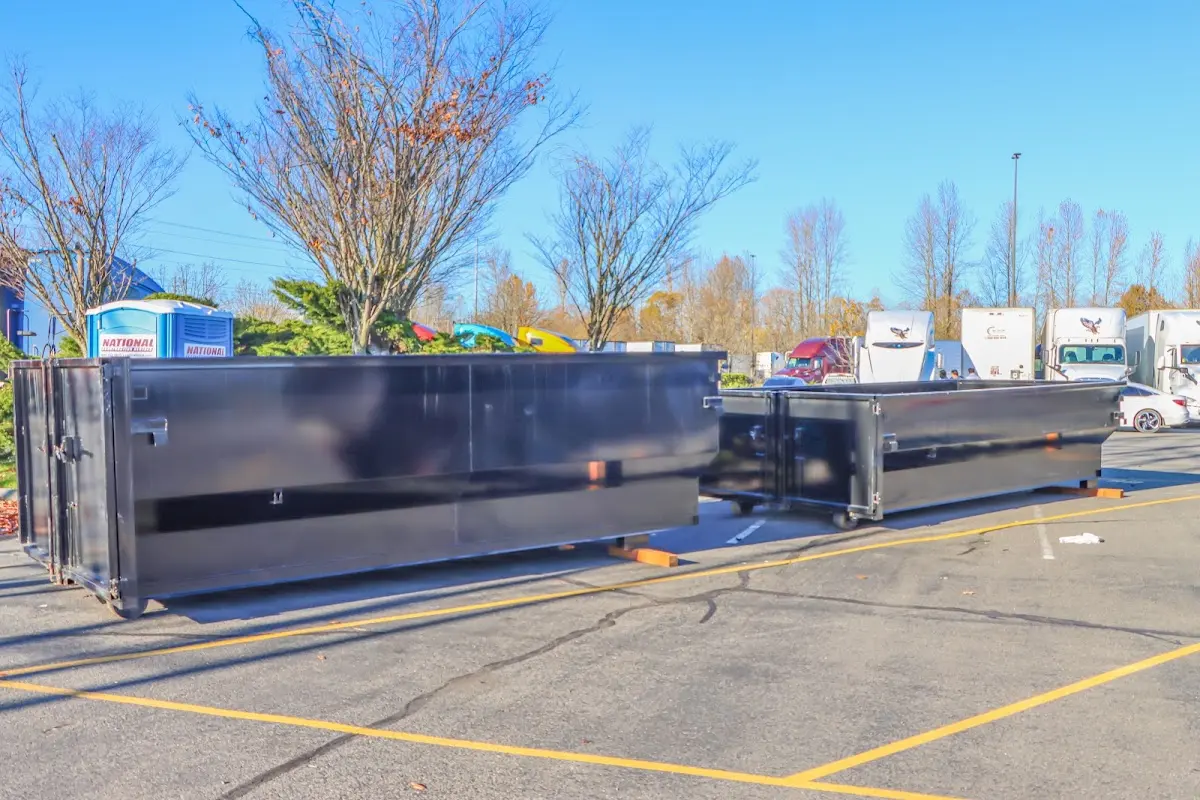 Professional dumpster rental service with roll-off container on residential driveway in Cullman